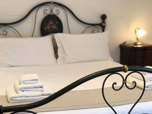 a bed with white towels sitting on top of it at Bed & Breakfast AMATI in Fasano