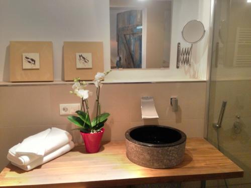a bathroom with a counter with a flower in a pot at Aparthotel Flughafen Leipzig in Freiroda