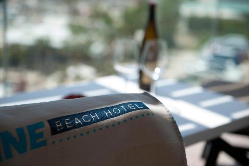 a bottle of wine sitting on top of a table at Folie Marine Hotel & Beach Club in Jal