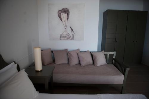 a living room with a couch and a table at Folie Marine Hotel & Beach Club in Jal