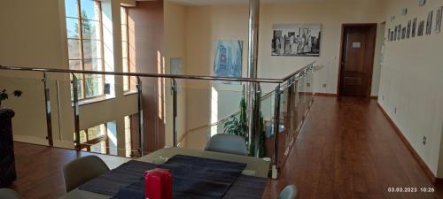 a staircase with a table and chairs in a room at Villa Homestay Nad Helmrovkou in Prague