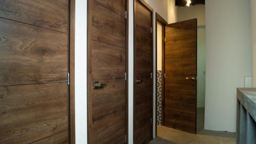 two views of a wooden door in a bathroom at Flore Hostel in Antigua Guatemala