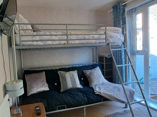 a bedroom with two bunk beds with a couch at The Chalet in Egremont