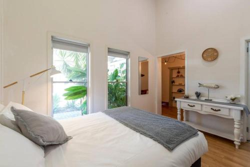 a white bedroom with a bed and a sink at Gawler Townhouses 1 Bedroom (1c) in Gawler