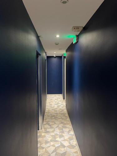 a hallway with black walls and a blue wall at Mary's Hotel République in Paris