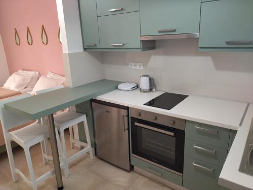 a small kitchen with a counter and a table at Panorama View in Agios Stefanos