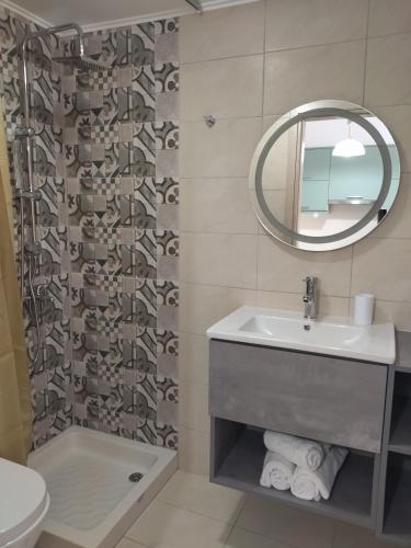 a bathroom with a sink and a mirror at Panorama View in Agios Stefanos