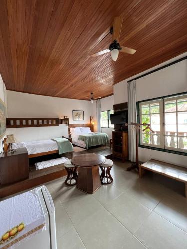 a bedroom with two beds and a ceiling fan at Cama e Café Tiradentes in Tiradentes