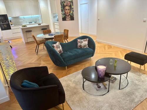 een woonkamer met 2 stoelen en een tafel bij Bel Appartement avec parking au coeur de Reims in Reims