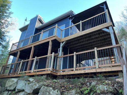 a large house on top of a rock at La Félicita chalet in Saint Adolphe D'Howard