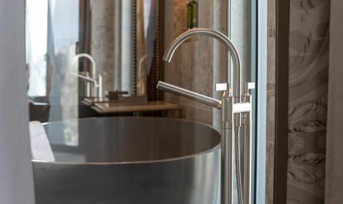 a bathroom with a metal sink and a mirror at Dos Reis by The Beautique Hotels in Lisbon