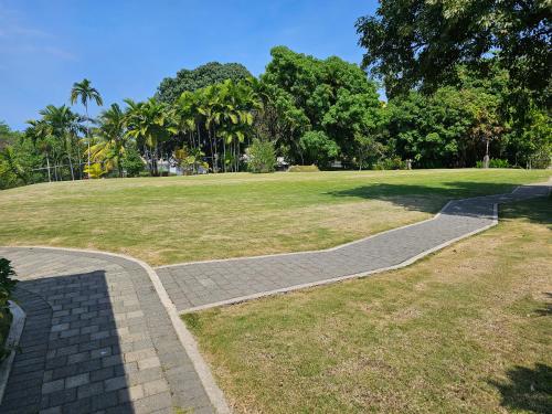 a walkway in a park with a grass field at Spicy Hill Villa in Port Antonio