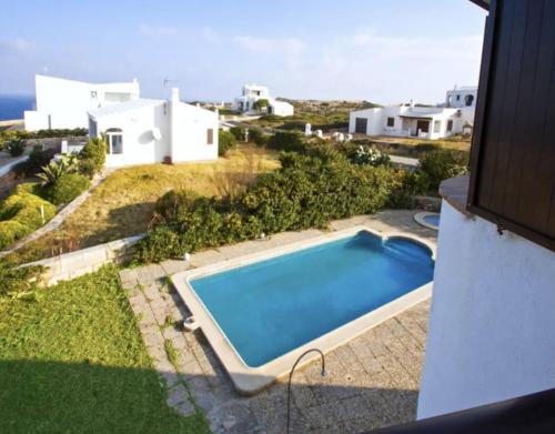 an overhead view of a swimming pool in front of a house at Villa MORELL in Cala Morell