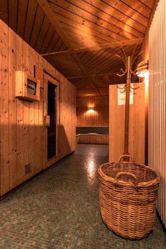 a room with a wicker basket in a building at Hotel Planac in Corvara in Badia