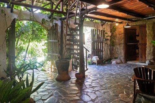 a room with a stone floor and a spiral staircase at Villa Havana in Mal País