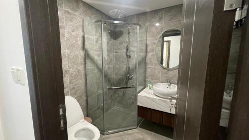 a bathroom with a shower and a toilet and a sink at LAD Apartment & Homestay Hải Phòng - Hoàng Huy Grand Tower in Hai Phong