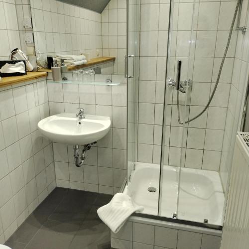 a bathroom with a shower and a sink and a tub at Bed and Breakfast Wehlen in Stadt Wehlen