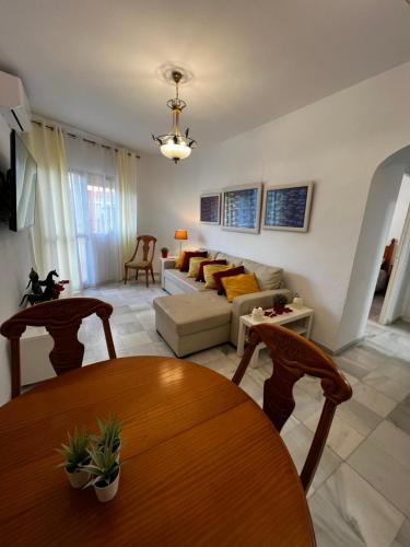 a living room with a table and a couch at Synergy Apartment, 2 bedroom, City Center in Torremolinos