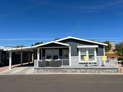 a black house with yellow chairs in front of it at Monte Vista Village Resort Mesa 3 Bed 2 Bath Age Restricted Must be 55 or more in Mesa