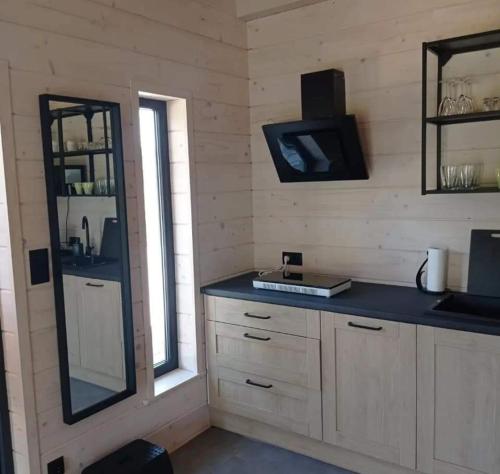 a kitchen with a counter and a tv on the wall at Jasna Chata Kluszkowce in Kluszkowce