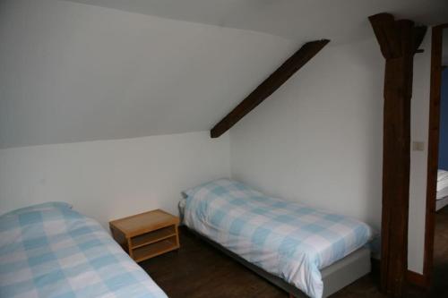 a bedroom with two beds and a shelf on the wall at Maison Marigoule - Perfect with kids & families in Mialet