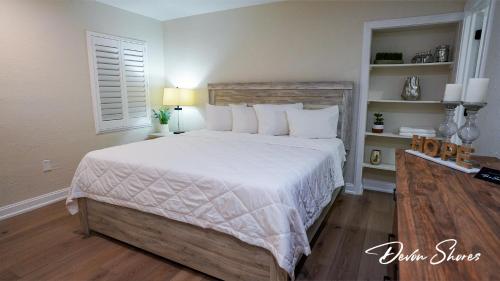 a bedroom with a large bed with white sheets and pillows at Devon Shores in Clearwater Beach