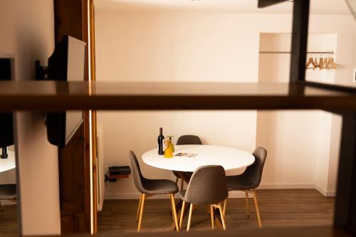 Appartamenti San Marco في باري: غرفة طعام مع طاولة بيضاء وكراسي