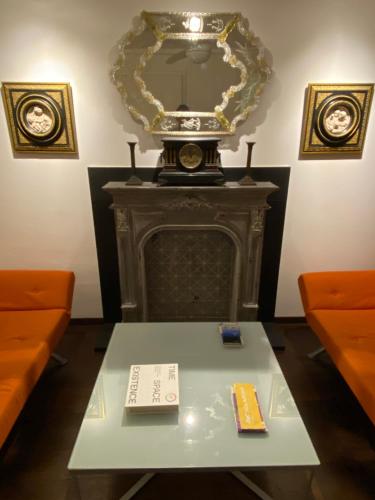 a table in front of a fireplace with a mirror at The Other Serenissima (With A/C) in Venice