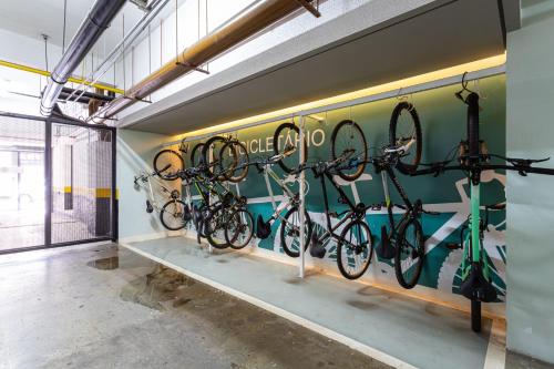 a room with bikes hanging on the wall at Aurora Paulistana by Viva - Prédio completo a passos do Metrô República in Sao Paulo
