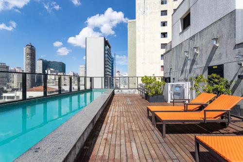 a balcony with a swimming pool on top of a building at Aurora Paulistana by Viva - Prédio completo a passos do Metrô República in Sao Paulo