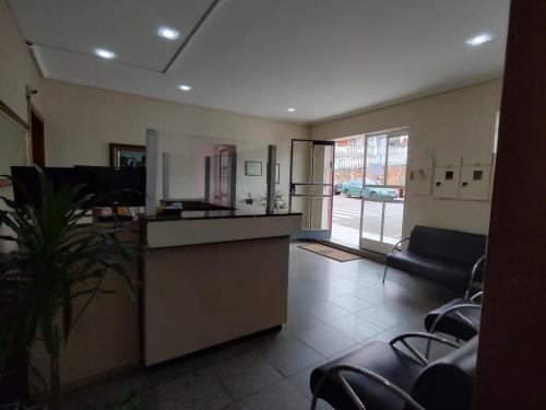 a lobby with a kitchen and a living room at Hotel Mirante da Serra in Ouro Branco