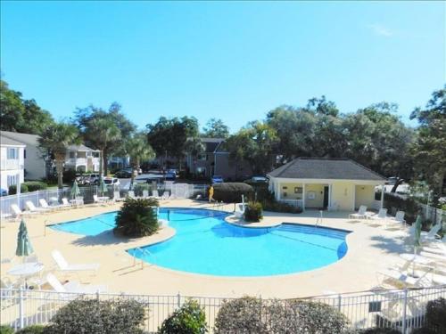 a large swimming pool with lounge chairs around it at c2 Ocean Walk Pool view village area cozy Upstairs sleeps 5 1 king bed two sleepers in Mallory Park