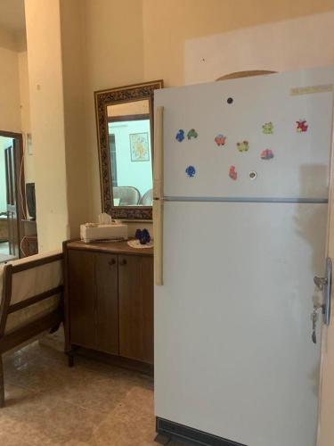 a white refrigerator in a room with a mirror at Bayt Ateeq 2 Bethlehem بيت دار عتيق in Bethlehem