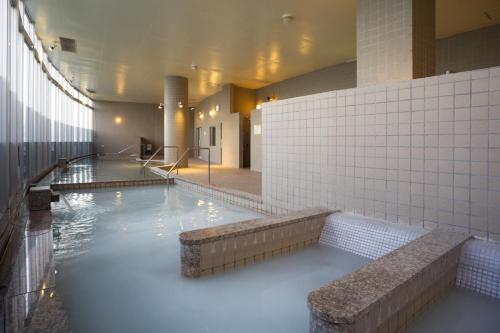 a large pool of water in a building at EM Wellness Kurashinohakko Lifestyle Resort in Kitanakagusuku