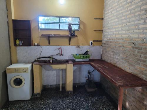 a small kitchen with a sink and a bench at El Hostal de Lucy in Luque
