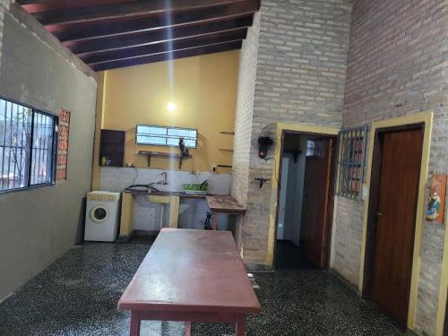 a kitchen with a wooden table in a room at El Hostal de Lucy in Luque