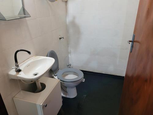 a bathroom with a toilet and a sink at El Hostal de Lucy in Luque