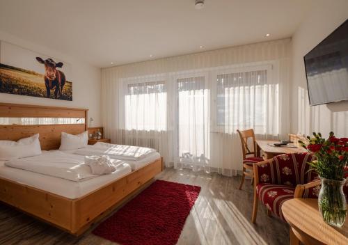 a bedroom with a bed and a table with a couch at ThälerHäusle in Furtwangen