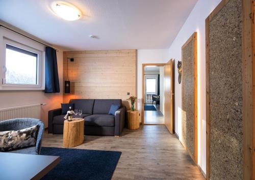 a living room with a couch and a table at ThälerHäusle in Furtwangen
