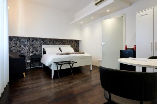 a bedroom with a bed and a table and chairs at Suite in Town in Bologna