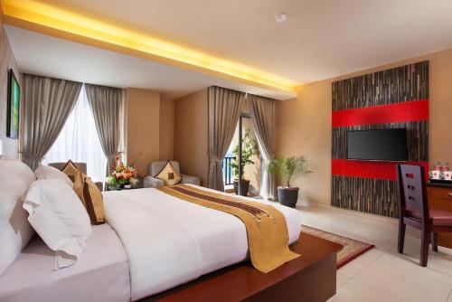a large bedroom with a large bed and a television at Lion Hotel & Plaza Manado in Manado