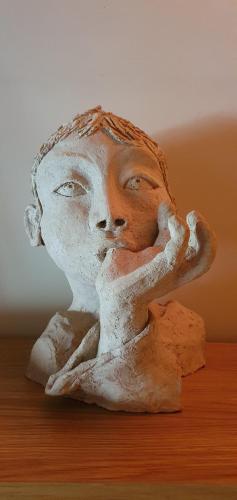 a statue of a woman with her hands on her face at Aux berges du pont du gard in Vers Pont du Gard