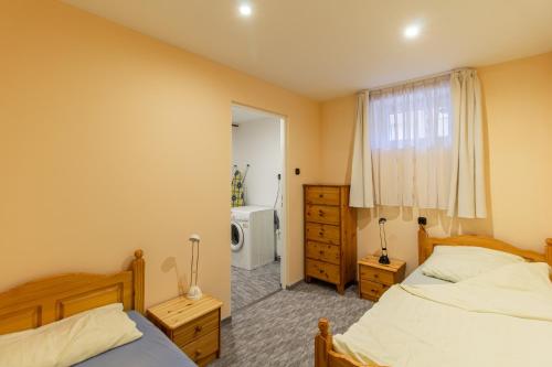 a bedroom with two beds and a window at Déli Terasz A Apartman Free parking, self-check-in anytime in Győr