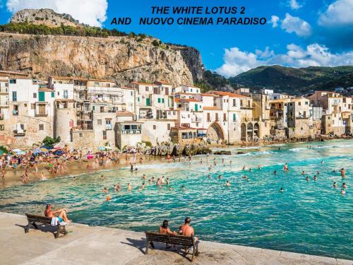 a group of people swimming in the water at a beach at La Casetta di Laura in Cefalù