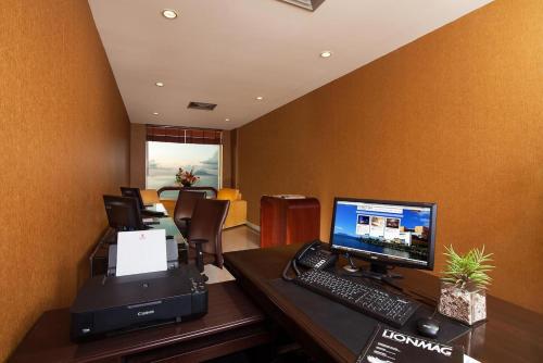 an office with a desk with a computer and a printer at Lion Hotel & Plaza Manado in Manado