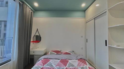 a bedroom with a bed and a window at LAD Apartment & Homestay Hải Phòng - Hoàng Huy Grand Tower in Hai Phong