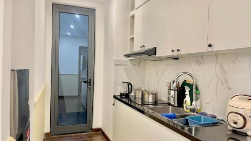 a kitchen with a sink and a counter top at LAD Apartment & Homestay Hải Phòng - Hoàng Huy Grand Tower in Hai Phong