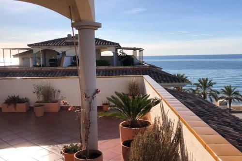 a house with a balcony with a view of the ocean at Seafront apartment with rooftop terrace and pool in Calafell
