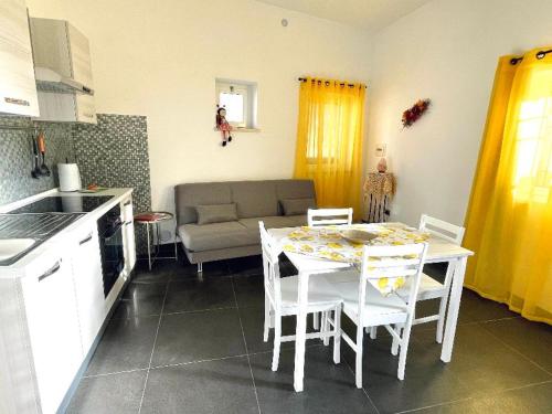 a kitchen and dining room with a table and chairs at CASA DANI in Tarquinia