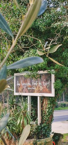 a sign for a park in front of a bush at Aux berges du pont du gard in Vers Pont du Gard